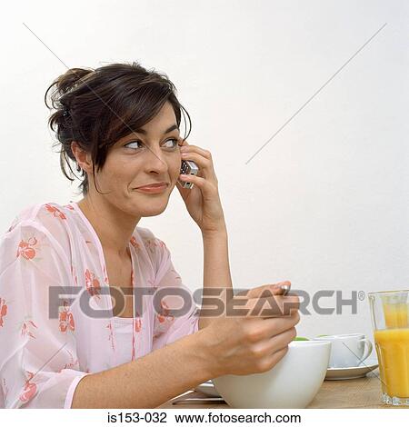 Woman on phone at breakfast View Large Photo Image Stock Image - Woman on phone at breakfast. Fotosearch