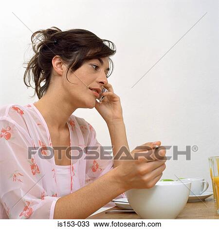 Woman on phone at breakfast View Large Photo Image Stock Image - Woman on phone at breakfast. Fotosearch