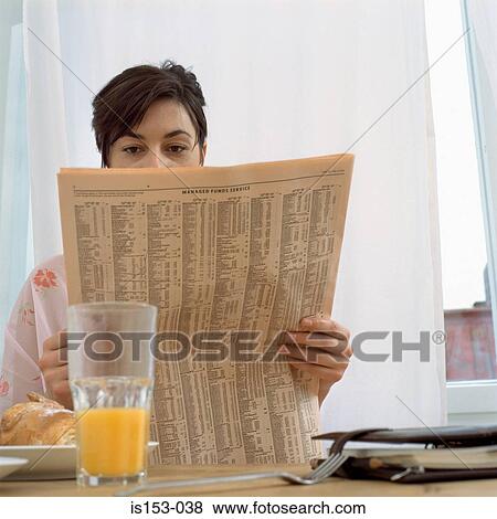 Woman with paper at breakfast View Large Photo Image Stock Photo - Woman with paper at breakfast. Fotosearch