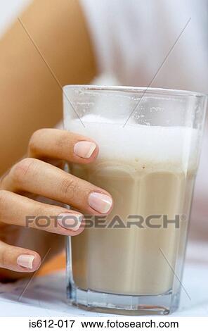 Stock Photo - Close-up of hand holding drink. Fotosearch