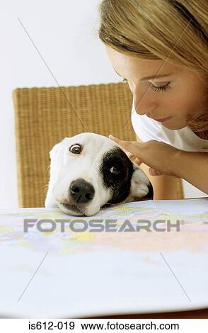 Stock Photo - Dog and lady owner with map. Fotosearch