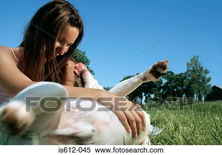 Stock Photography - Lady owner playing with dog. Fotosearch