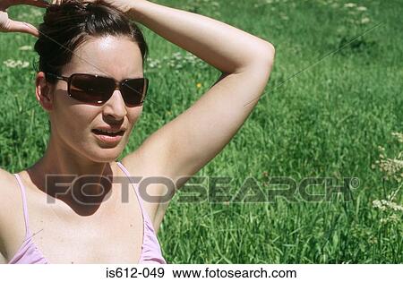 Woman fixing hair outdoors View Large Photo Image Stock Photo - Woman fixing hair outdoors. Fotosearch