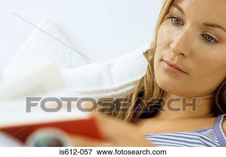 Woman reading indoors View Large Photo Image Stock Photo - Woman reading indoors. Fotosearch