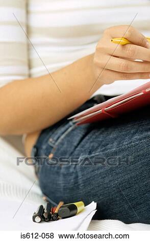Stock Photo - Woman using paper and pens. Fotosearch