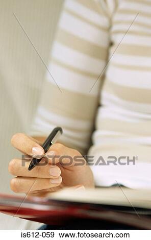Stock Photo - Woman using pen and paper. Fotosearch