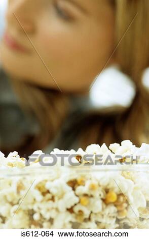 Woman with bowl of popcorn View Large Photo Image Picture - Woman with bowl of popcorn. Fotosearch