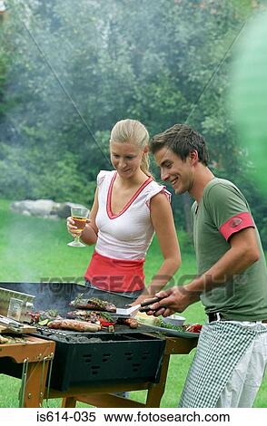Stock Photography - Friends cooking on barbeque.. Fotosearch