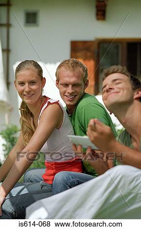 Friends siting outdoors View Large Photo Image Stock Photo - Friends siting outdoors. Fotosearch