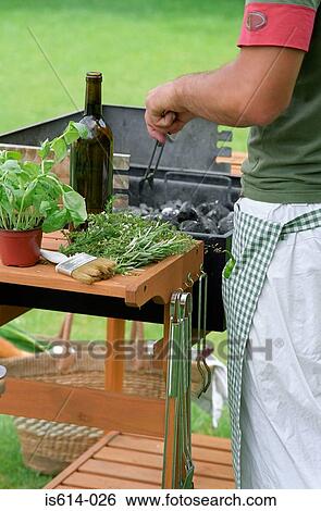 Male arranging barbeque coals. View Large Photo Image Stock Photograph - Male arranging barbeque coals.. Fotosearch