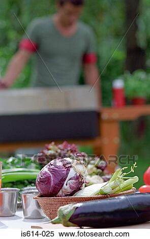 Stock Photography - Preparing meal al fresco.. Fotosearch