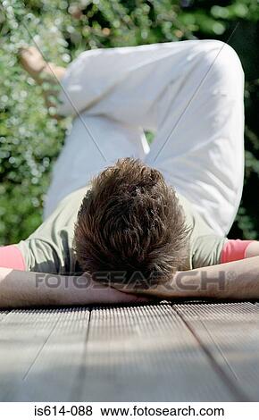 Stock Photo - Relaxed young male lying down.. Fotosearch
