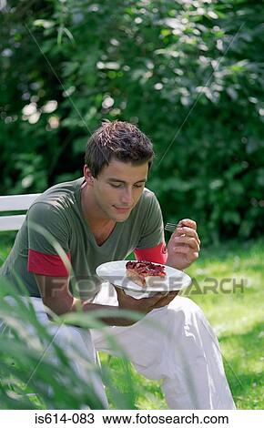 Young man eating dessert. View Large Photo Image Stock Image - Young man eating dessert.. Fotosearch