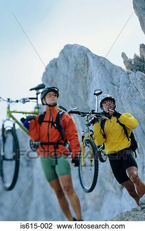 Stock Image - Carrying bikes in the mountains.. Fotosearch