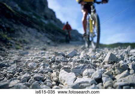 Stock Photography - Cycling on rocky path.. Fotosearch