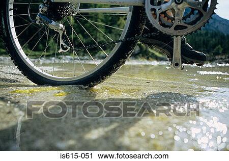Cyclist crossing stream. View Large Photo Image Stock Image - Cyclist crossing stream.. Fotosearch