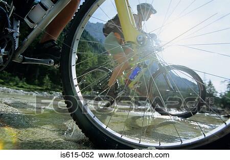 Cyclists crossing stream. View Large Photo Image Stock Image - Cyclists crossing stream.. Fotosearch