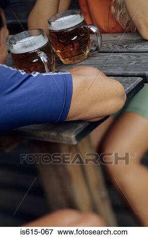 Cyclists having pints of beer. View Large Photo Image Stock Photo - Cyclists having pints of beer.. Fotosearch
