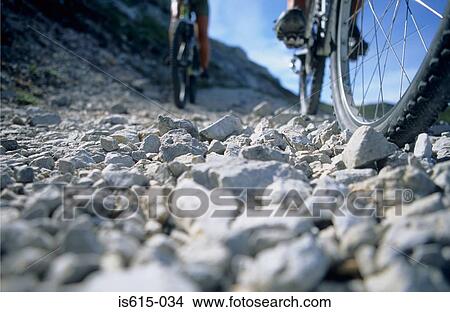 Cyclists on rocky hillside. View Large Photo Image Picture - Cyclists on rocky hillside.. Fotosearch
