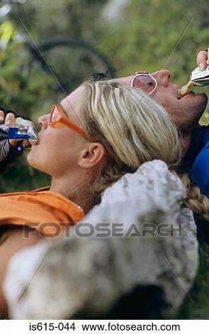 Cyclists resting and eating. View Large Photo Image Picture - Cyclists resting and eating.. Fotosearch