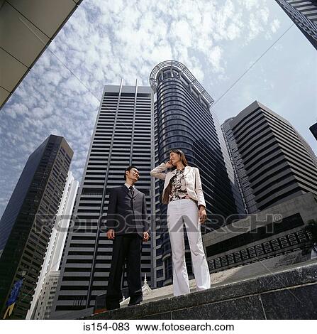 Asian businesspeople using a cellular telephone View Large Photo Image Stock Image - Asian businesspeople using a cellular telephone. Fotosearch