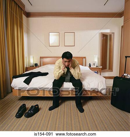 Bored businessman in hotel room View Large Photo Image Stock Image - Bored businessman in hotel room. Fotosearch