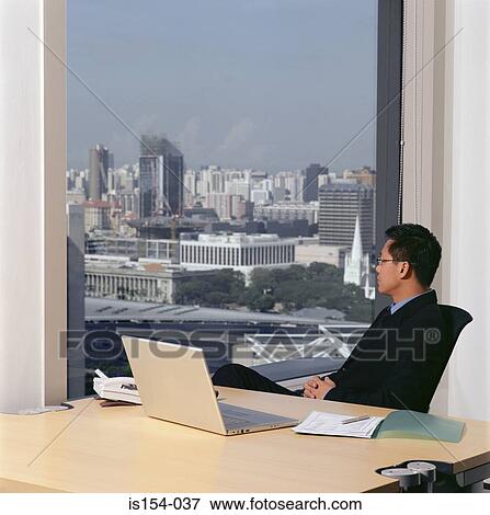 Businessman at desk View Large Photo Image Stock Photo - Businessman at desk. Fotosearch