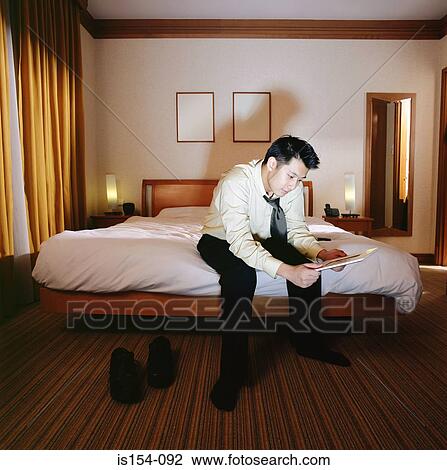 Businessman looking at photograph View Large Photo Image Stock Image - Businessman looking at photograph. Fotosearch