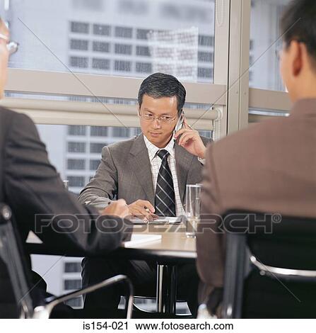 Businessman using a cellular telephone View Large Photo Image Stock Image - Businessman using a cellular telephone. Fotosearch