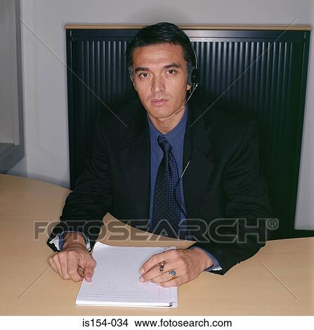 Businessman using a telephone headset View Large Photo Image Picture - Businessman using a telephone headset. Fotosearch