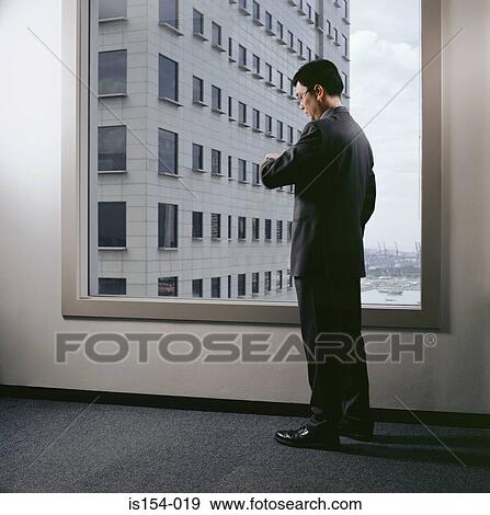 Businessman waiting in office View Large Photo Image Stock Photo - Businessman waiting in office. Fotosearch