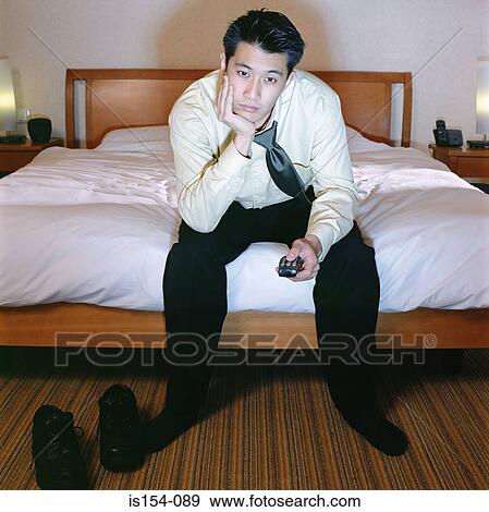 Businessman watching television View Large Photo Image Stock Photo - Businessman watching television. Fotosearch