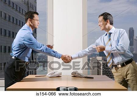 Businessmen shaking hands View Large Photo Image Stock Photograph - Businessmen shaking hands. Fotosearch