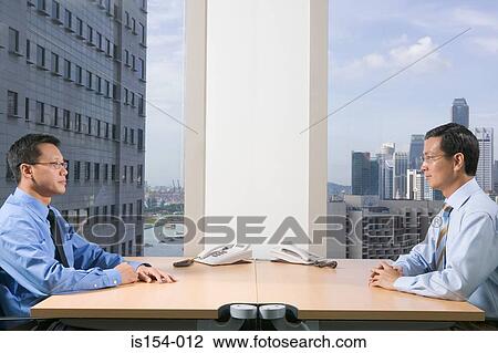 Businessmen sitting face to face View Large Photo Image Stock Image - Businessmen sitting face to face. Fotosearch