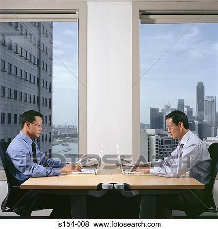 Businessmen using laptop computers View Large Photo Image Stock Photo - Businessmen using laptop computers. Fotosearch