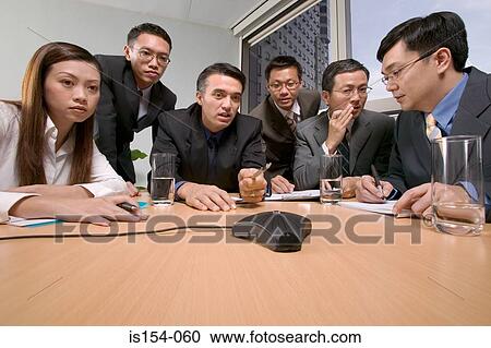 Businesspeople having a conference call View Large Photo Image Stock Image - Businesspeople having a conference call. Fotosearch