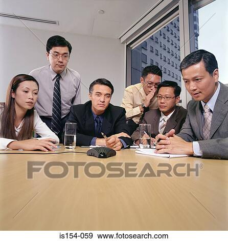 Businesspeople having a conference call View Large Photo Image Stock Photo - Businesspeople having a conference call. Fotosearch