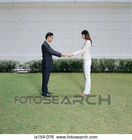 Businesspeople having tug of war with telephone View Large Photo Image Stock Photograph - Businesspeople having tug of war with telephone. Fotosearch