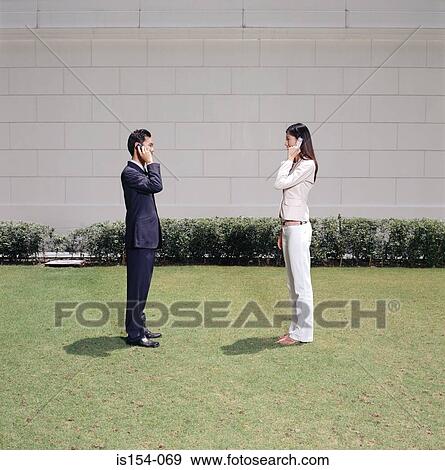 Businesspeople using cellular telephones View Large Photo Image Stock Photo - Businesspeople using cellular telephones. Fotosearch