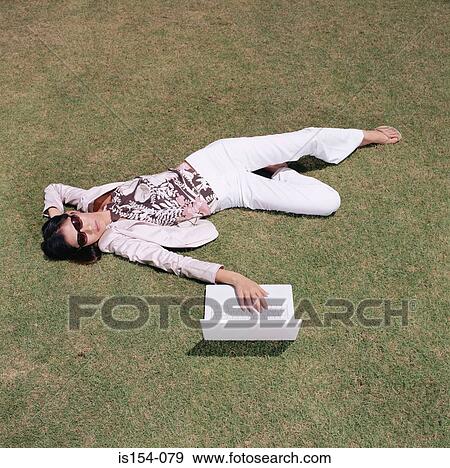 Businesswoman relaxing in field View Large Photo Image Stock Photo - Businesswoman relaxing in field. Fotosearch