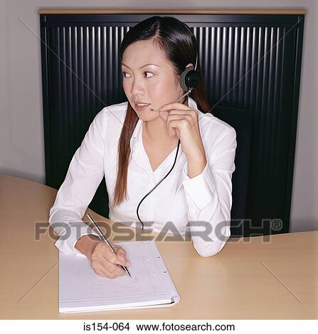 Businesswoman wearing a telephone headset View Large Photo Image Picture - Businesswoman wearing a telephone headset. Fotosearch