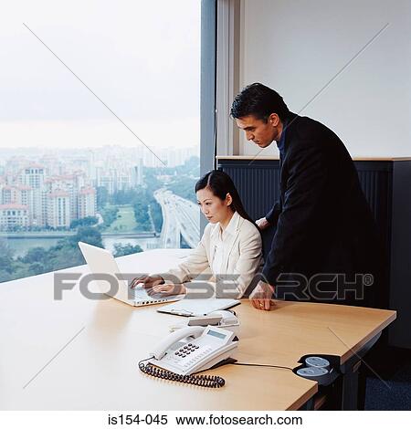 Two businesspeople in office View Large Photo Image Stock Photography - Two businesspeople in office. Fotosearch