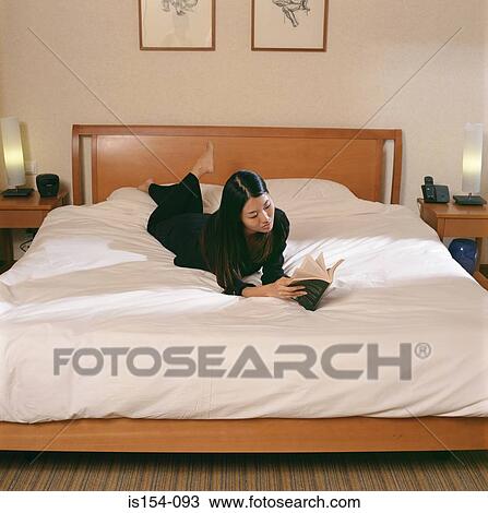 Woman reading on bed View Large Photo Image Stock Image - Woman reading on bed. Fotosearch