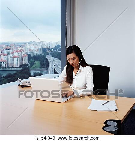 Young businesswoman working in office View Large Photo Image Stock Photo - Young businesswoman working in office. Fotosearch