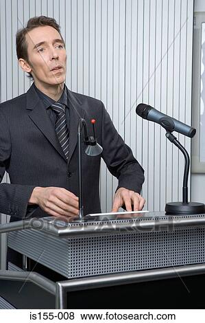 Businessman at podium View Large Photo Image Stock Photo - Businessman at podium. Fotosearch