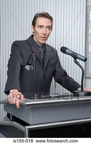 Stock Photo - Businessman at podium. Fotosearch