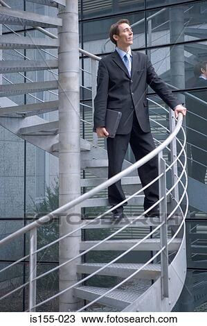 Businessman on spiral staircase View Large Photo Image Stock Image - Businessman on spiral staircase. Fotosearch