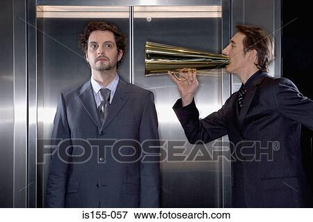 Businessman using a megaphone View Large Photo Image Stock Photo - Businessman using a megaphone. Fotosearch
