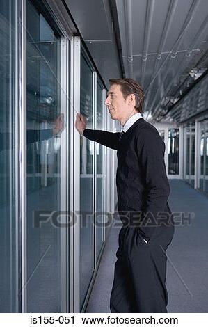 Stock Image - Businessman waiting by door. Fotosearch
