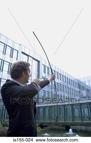 Businessman with bow and arrow View Large Photo Image Picture - Businessman with bow and arrow. Fotosearch